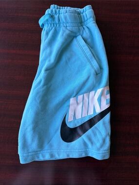 Nike Light Blue Kids Shorts with Black Swoosh and White Logo